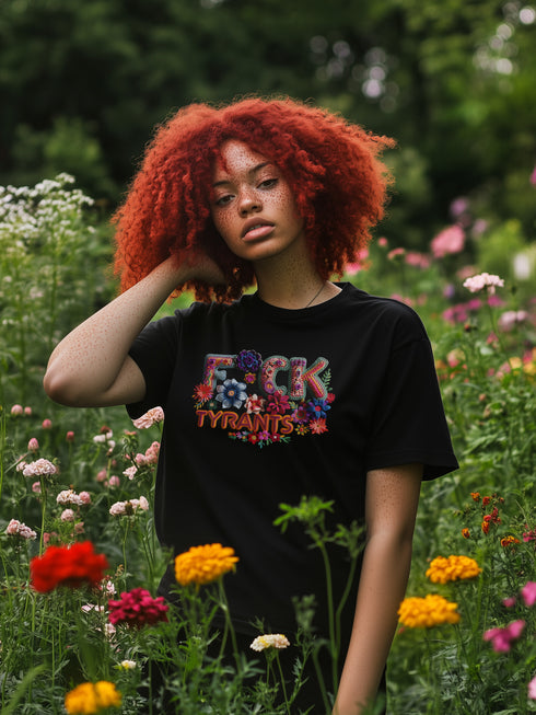 Black unisex T-shirt with bold floral embroidery-style text reading "F*ck Tyrants" in vibrant colors.